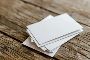 Blank business cards stacked on rustic wooden table photo