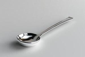 Shiny stainless steel soup spoon on a light background photo