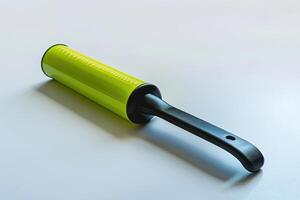 A bright green lint roller rests on a clean surface, ready for use photo