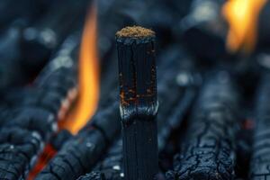 Charcoal burning with glowing embers in a barbecue grill during the evening hours photo