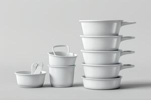 Stacked white kitchen containers with handles on a light background photo