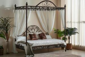 Elegant metal canopy bed with white curtains in a bright indoor setting photo