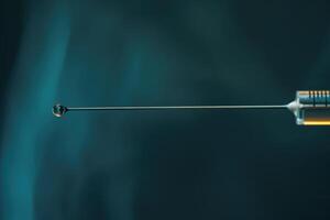A close-up view of a syringe with a droplet at the tip, highlighting medical equipment in a clinical setting photo