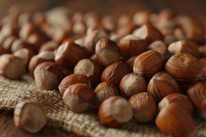 Freshly harvested hazelnuts scattered on burlap cloth in a rustic setting photo