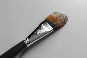 Close-up of a makeup brush displaying vibrant bristles and subtle color variations on a smooth surface photo