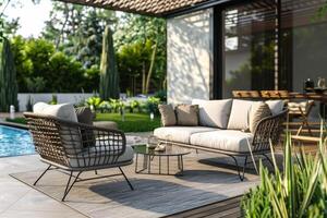 Cozy outdoor seating area with a swimming pool surrounded by lush greenery in a sunny garden photo
