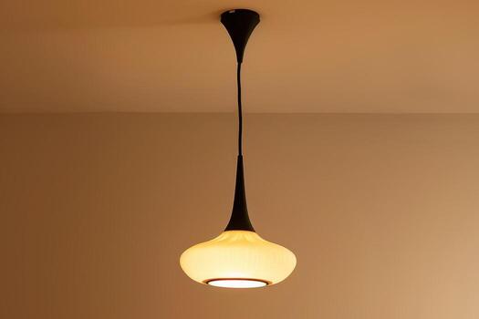 Modern hanging light fixture in a minimalist interior setting photo