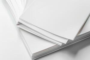 A stack of blank sheets of paper resting on a smooth surface indoors during daylight photo
