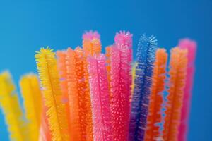Colorful bristle cleaning sticks displayed against a blue background photo