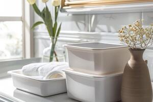 Elegant bathroom setup with stacked storage containers and fresh flowers at midday photo