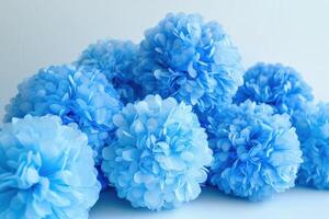 Blue decorative pom-poms arranged together on a light background photo