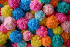 Colorful pom-poms spread across a vibrant surface during a craft project in a bright workspace photo