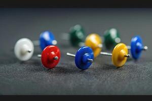 Colorful push pins arranged in a creative pattern on a textured surface during daylight photo