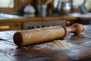 Wooden rolling pin rests on a flour-dusted kitchen countertop during baking preparations at home photo