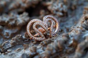 Elegant rose gold earrings with sparkling gemstones displayed on a textured surface photo