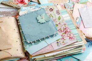 Detailed scrapbooking materials arranged on a table with a vintage feel, showcasing handmade decorative elements and various textured papers photo