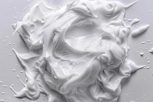 Creamy white mixture spread across a smooth surface with glossy texture and droplets photo