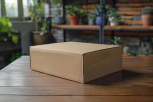 A closed cardboard box placed on a wooden table in a green indoor garden setting during the afternoon photo