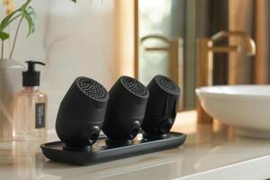 Modern bathroom counter with three stylish black soap dispensers and elegant sink in a bright, well-lit space photo