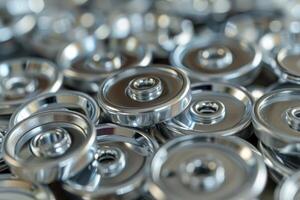 Close-up view of shiny metal weights piled together in a gym setting during the day photo
