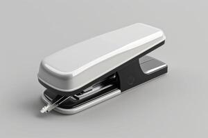 A sleek, modern stapler positioned on a smooth surface in a well-lit workspace, showcasing its design and functionality photo