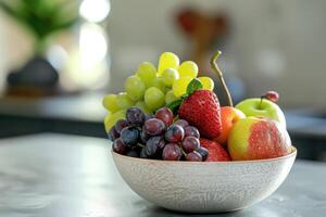 A colorful assortment of fresh fruits in a bowl on a kitchen countertop photo