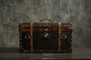 Vintage wooden trunk with metal accents and leather straps on a rustic table photo