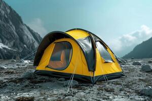 A yellow camping tent set up on rocky terrain in a mountainous area under a bright sky during daytime photo