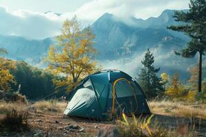 A cozy tent set up in a serene mountain landscape during autumn photo