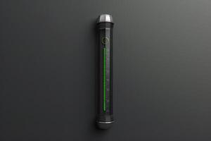 A sleek digital thermometer mounted on a dark wall displaying a green temperature reading photo