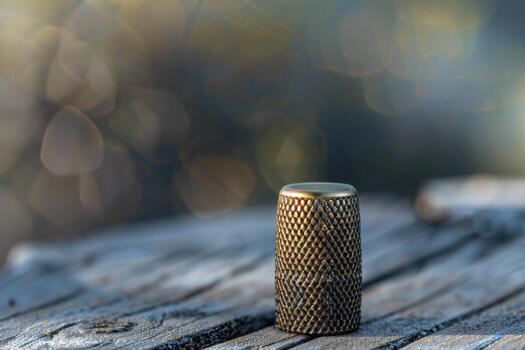 A close-up of a textured metal object resting on an old wooden surface outdoors in soft natural light photo