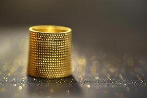 A decorative golden ring placed on a textured surface with a sparkling background photo