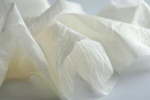 Close-up of crumpled white fabric on a smooth surface photo