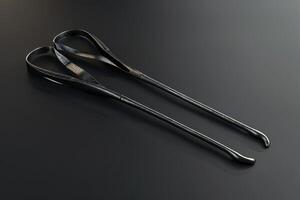 Vintage black shoehorns displayed on a dark surface photo