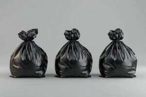 Three black trash bags arranged in a line on a grey background photo