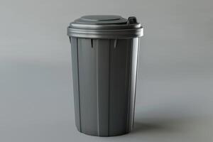 A gray trash can on a neutral background captured indoors photo