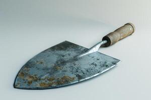 Rusty garden trowel resting on a plain background photo