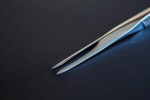 Precision scissors on a dark surface showcasing sharp tips and sleek design photo