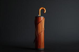 A vintage wooden cane with a gold curved handle rests against a dark backdrop photo