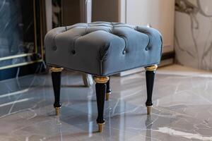 Elegant tufted stool with black legs in a modern living room setting photo