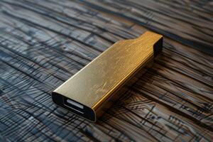 Gold USB flash drive on wooden surface with abstract patterns in natural light photo