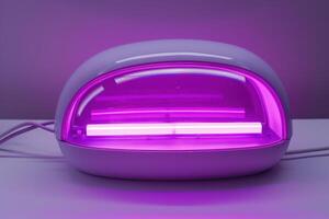 UV nail lamp with purple glow set on a white surface photo