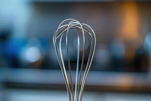 Stainless steel whisk blurred in kitchen setting during daytime preparation photo