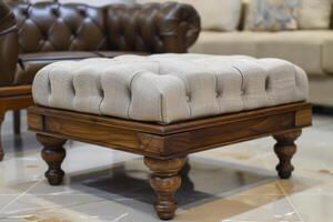 Elegant tufted ottoman on wooden legs in a modern living room setting photo
