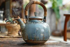 Handcrafted ceramic teapot with steam rising outdoors in a tranquil setting during the day photo