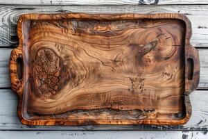 Elegant handcrafted wooden serving tray with unique grain patterns on a rustic wooden table photo
