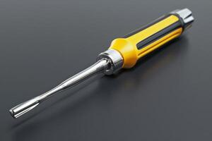Yellow and silver screwdriver resting on a black surface, highlighting its sleek design and utility photo