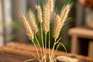 Wheat stalks arranged in a rustic setting with greenery in the background during golden hour photo
