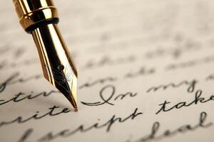 fountain pen on paper with ink text on the paper photo