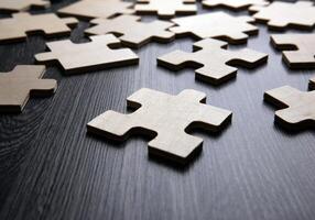 puzzle elements on a wooden background as a riddle photo